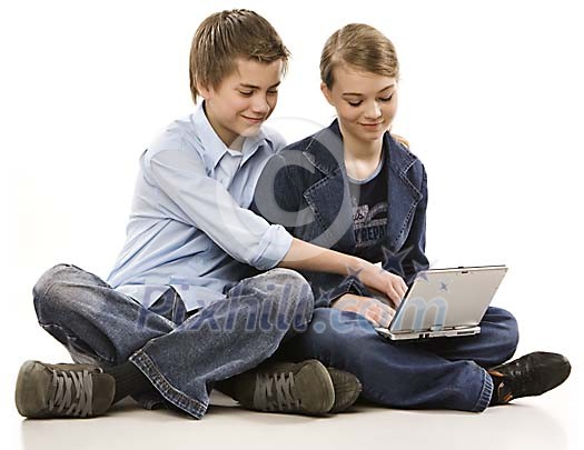 Teenagers sitting behind a computer