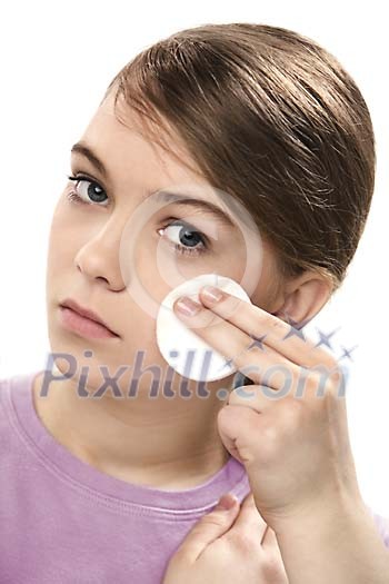 Teenager cleansing her face Teenager cleansing her face