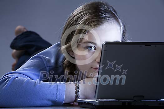 Girl with a laptop on the floor