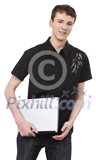 Teenage boy standing with a laptop
