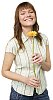 Teenage girl smiling and holding a gerbera