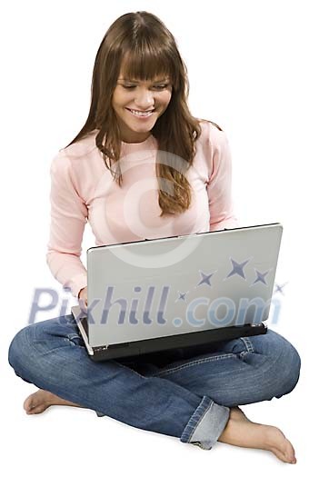 Isolated girl sitting on the floor with a laptop