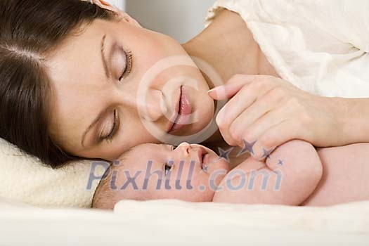 Woman with a small baby on the bed Woman with a small baby on the bed