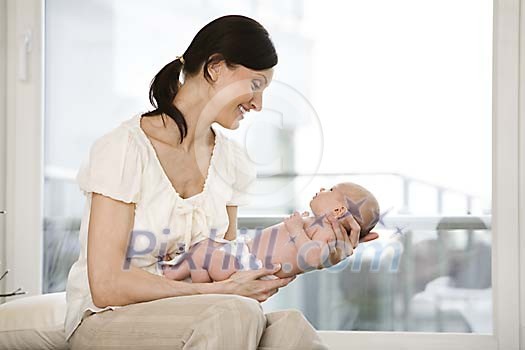 Woman sitting and holding a little baby