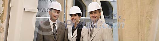 Men and a women smiling at the construction site