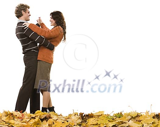 Couple dancing on the autumn leaves