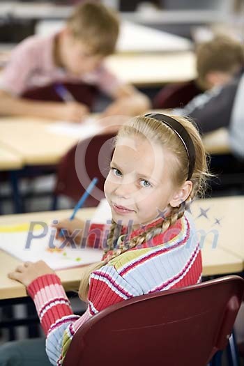 Young girl sitting in the classroom