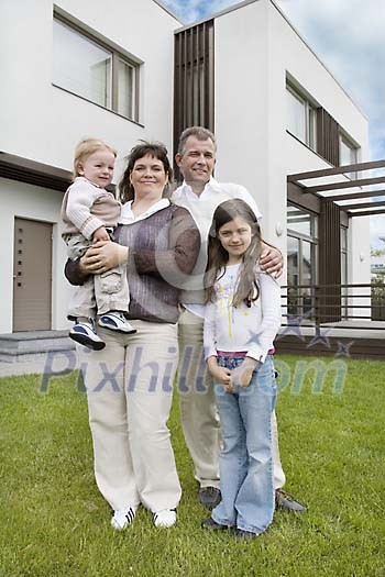 Family in front of a new house