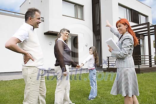 Family with real estate agent looking at a house