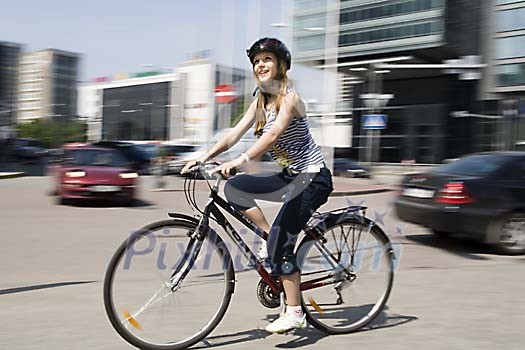 Woman biking in the city streets