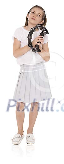 Isolated girl standing with a tambourine