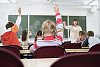 Students hands up in the classroom