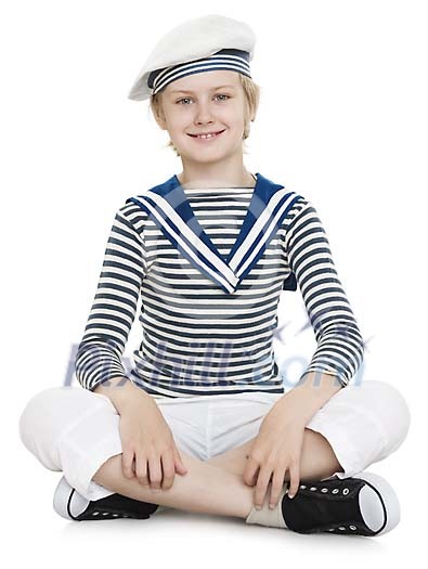 Isolated boy dressed as a sailor sitting on the floor Isolated boy dressed as a sailor sitting on the floor