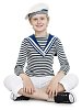 Isolated boy dressed as a sailor sitting on the floor