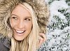 Woman smiling while snowing