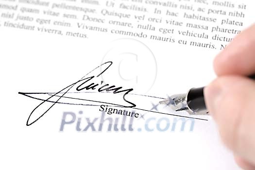 Hand writing a signature on the paper Hand writing a signature on the paper