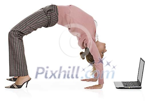 Isolated woman doing a backflip in front of the laptop