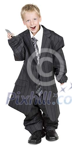Isolated boy wearing too big business suit. holding a mobile