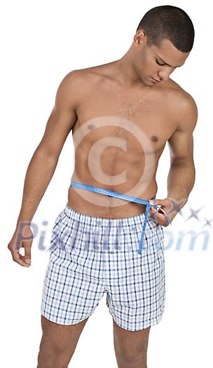 Isolated man measuring his waist