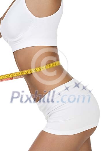 Isolated female body with a measuring tape around the waist