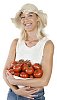 Isolated woman holding a pile of tomatoes in her arms