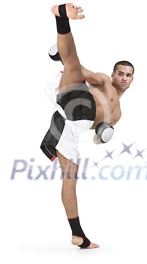 Isolated male kickboxer kicking