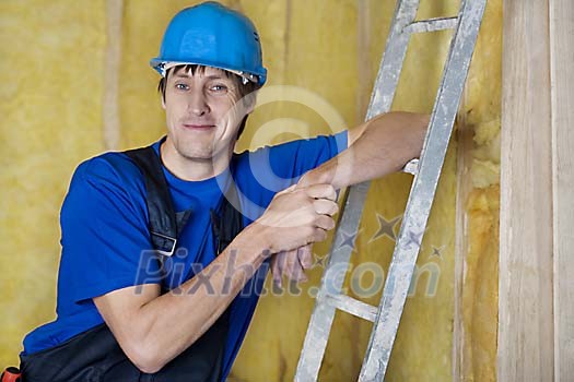 Male carpenter smiling at worksite Male carpenter smiling at worksite