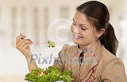 Woman eating a green salad