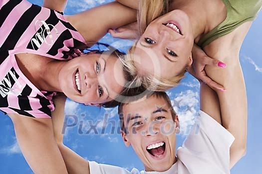 Group of teenagers looking down and smiling