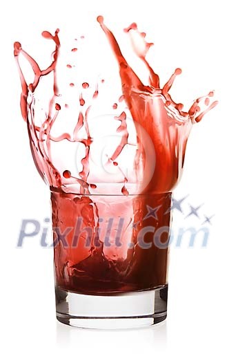 Red drink splashing out of the glass