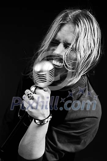 Black and white image of male singer singing