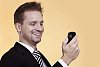 Businessman smiling while looking at his phone