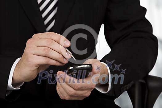 Businessman checking e-mails from his phone