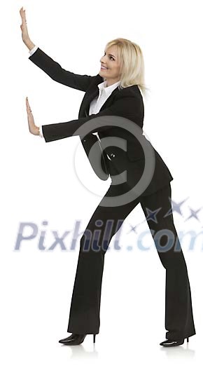 Isolated businesswoman pushing a wall