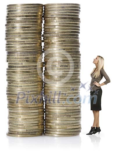 Isolated woman looking at the oversized towers of coins
