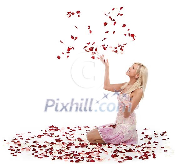 Woman sitting on the floor surrounded bu flower petals