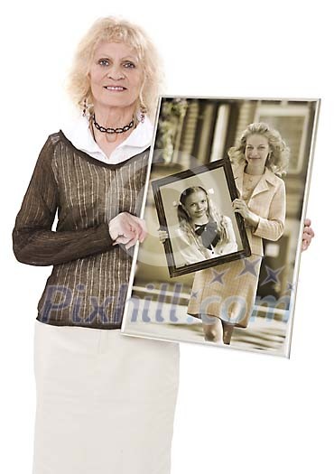 Older woman showing a photo of two her daughter and a granddaughter