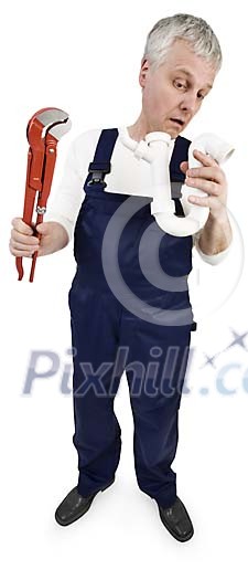 Isolated plumber man looking in to a pipe
