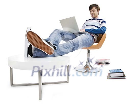 Man sitting with his feet on the table, using laptop