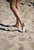 Female feet on the beach sand