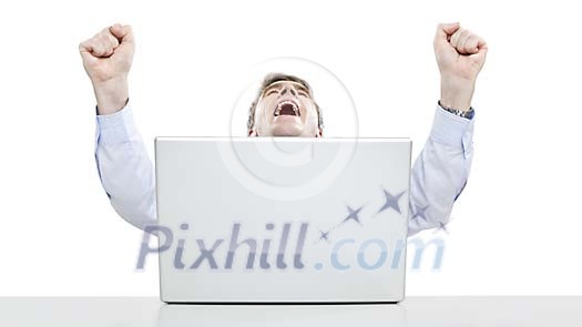 Successful businessman with hands in the air at his desk