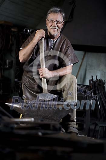 Male blacksmith with his hammer Male blacksmith with his hammer
