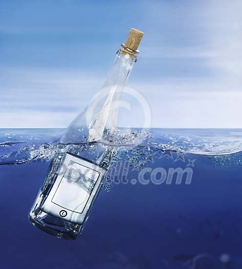 Glass bottle in the water with a mobile phone in it