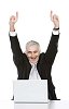 Isolated senior businessman cheering behind a laptop
