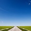 Empty road under a blue sky