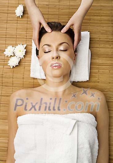 Woman getting head massage treatment