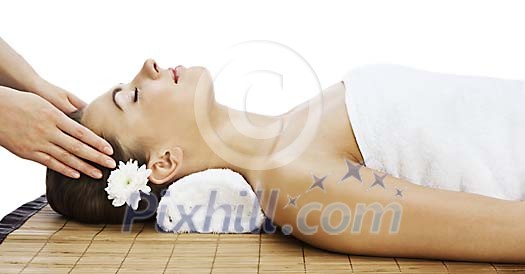 Woman getting head massage in spa
