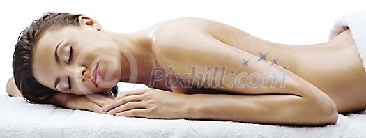 Beautiful woman lying  relaxed on towels