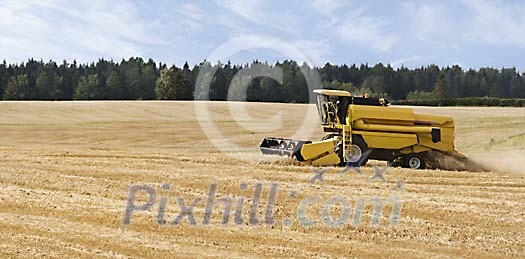 Lonely combined harvester on field