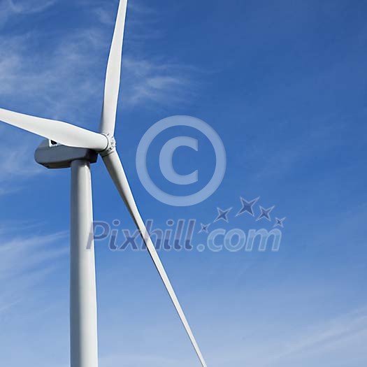 Close-up of a windmill against blue sky